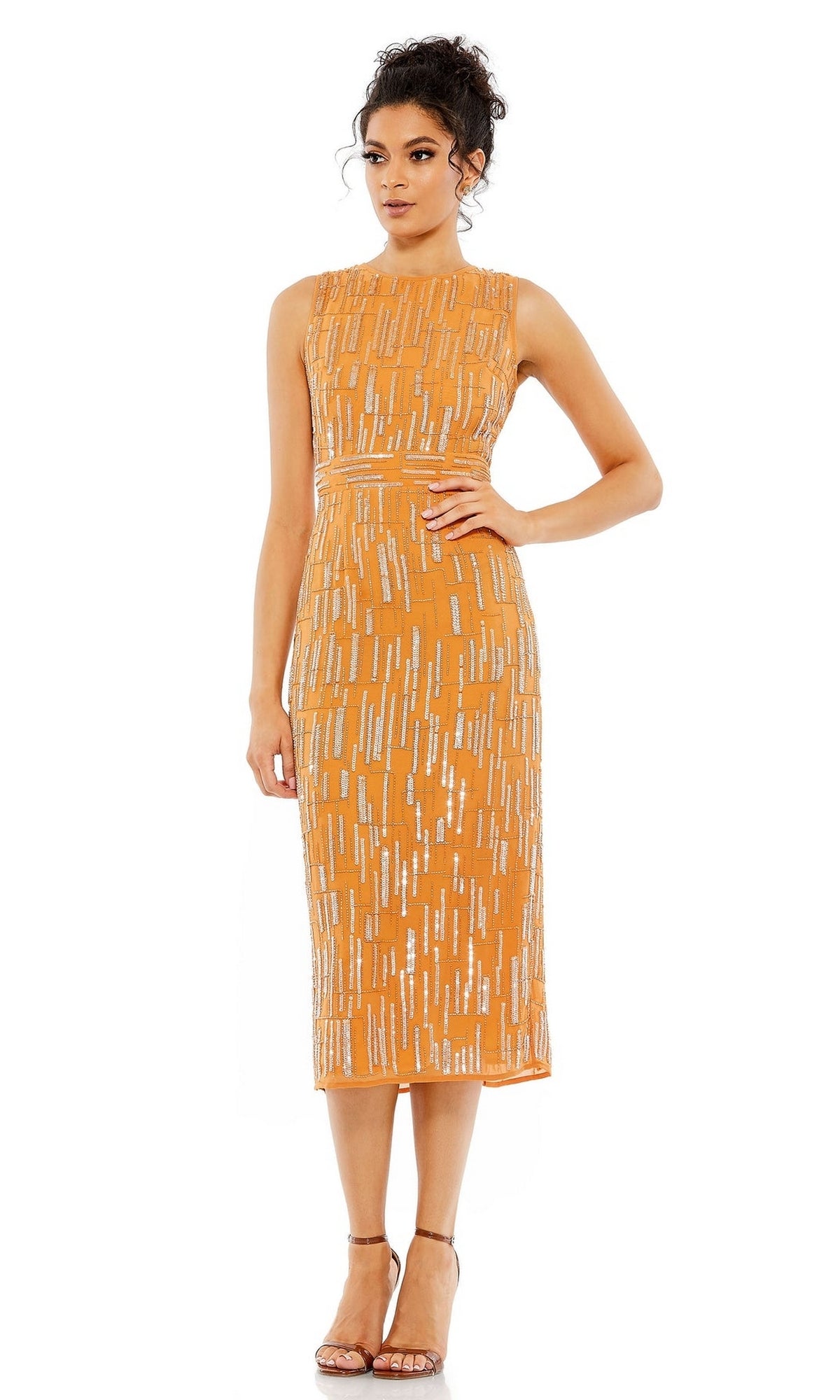 A woman stands against a white background wearing the Mac Duggal 70264 Beaded Midi Wedding Guest Dress, a sleeveless orange party dress with silver sequin patterns, paired with strappy heels.
